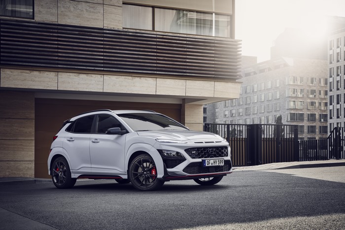 White Hyundai Kona N SUV parked in front of modern building