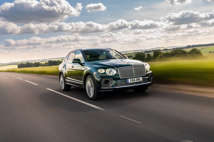 Dark green Bentley Bentayga SUV on a country road