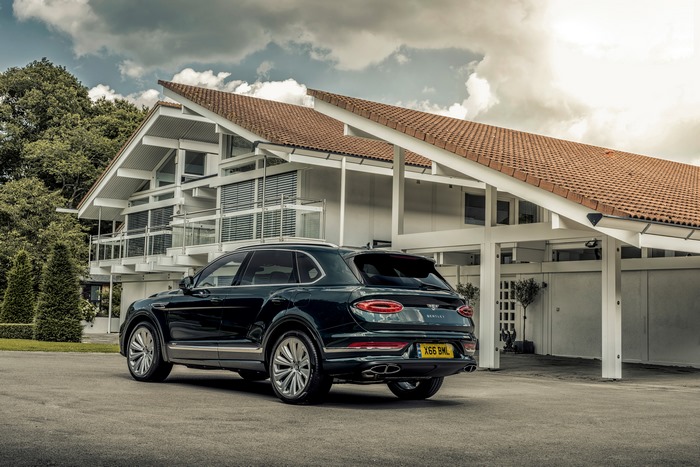 Bentley Bentayga SUV parked outside a contemporary house