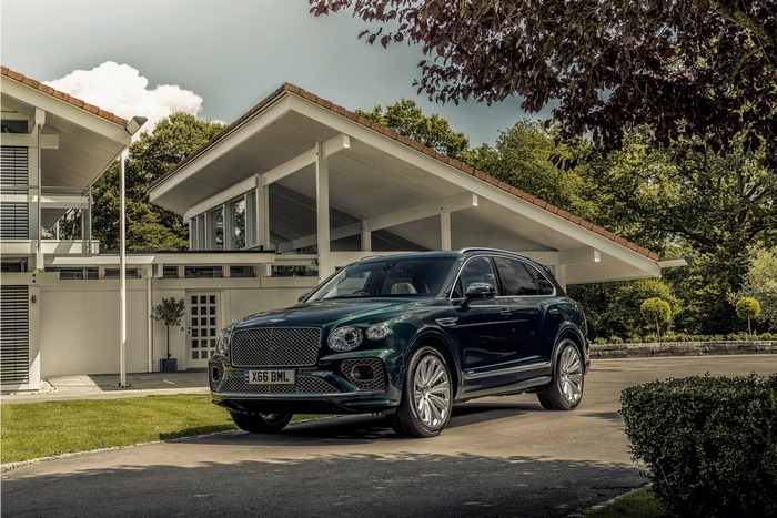 Dark green Bentley Bentayga Hybrid SUV at modern house
