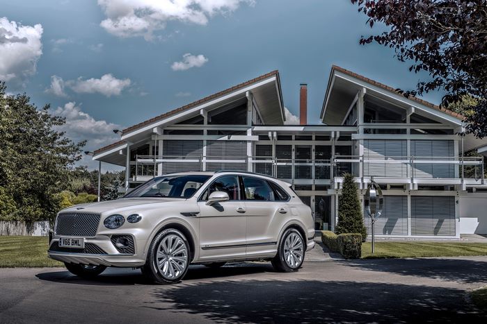 Bentley Bentayga SUV at a striking modern home