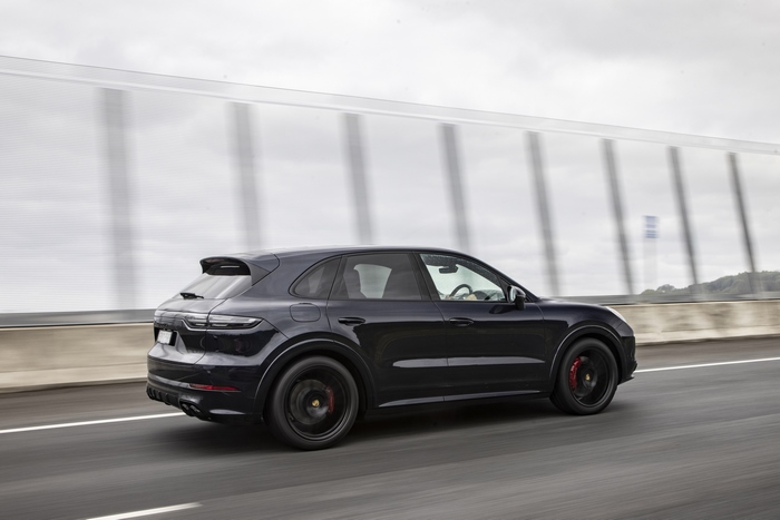 Black Porsche Cayenne GTS SUV driving on highway