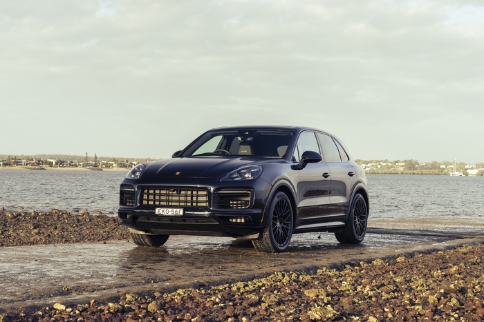 Black Porsche Cayenne GTS SUV by the water