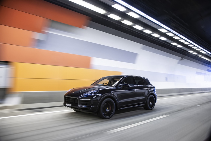 Black Porsche Cayenne GTS driving through a tunnel