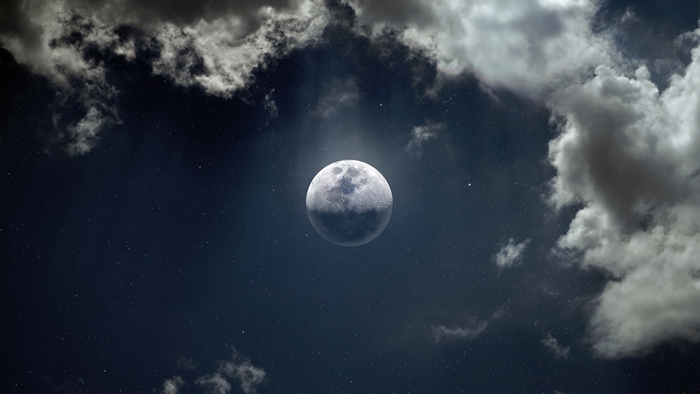 Moon and clouds in a starry night sky