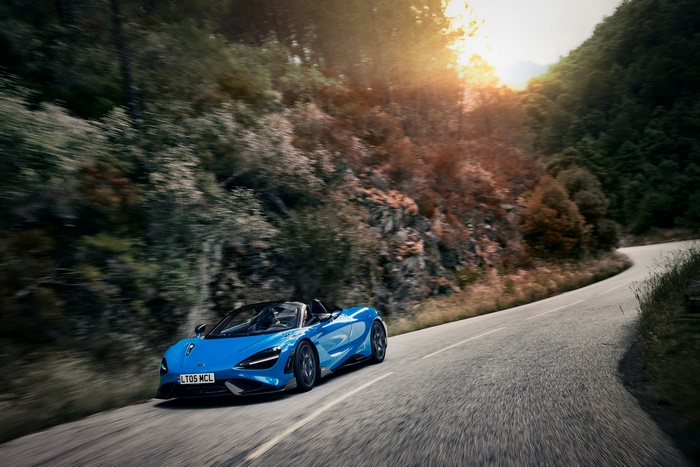 McLaren 765LT Spider driving through mountains at sunset