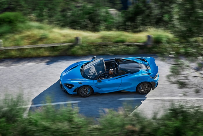 Blue McLaren 765LT Spider speeding on road