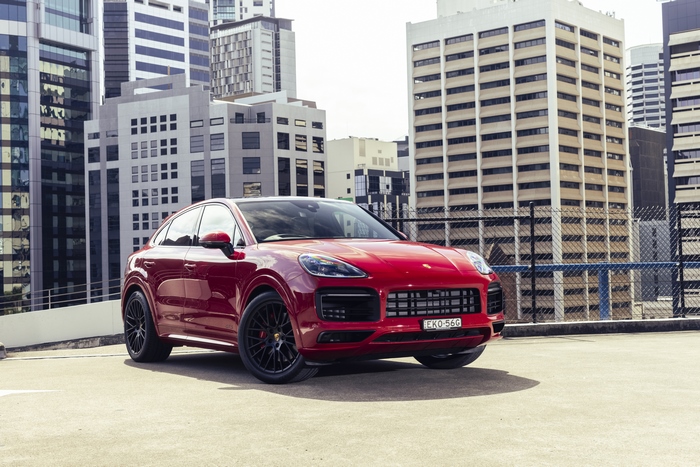 Red Porsche Cayenne GTS Coupé parked on a city rooftop