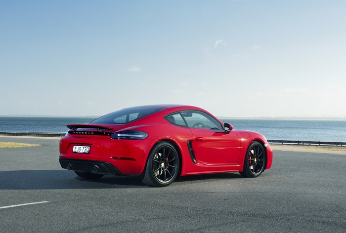 Red Porsche 718 Cayman GTS 4.0 sport car by the sea
