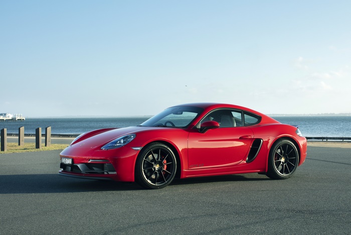 Red Porsche 718 Cayman GTS by the sea