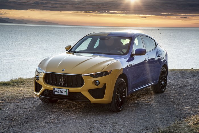 Two-tone Maserati Levante GT Hybrid by the sea at sunset