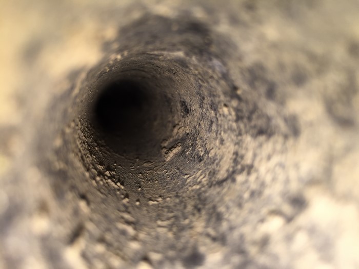 Macro view of a dark, textured tunnel