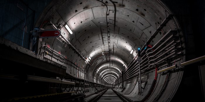 Illuminated Underground Train Tunnel with Tracks