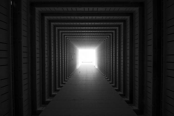 Monochrome Tunnel Architecture Leading to Light