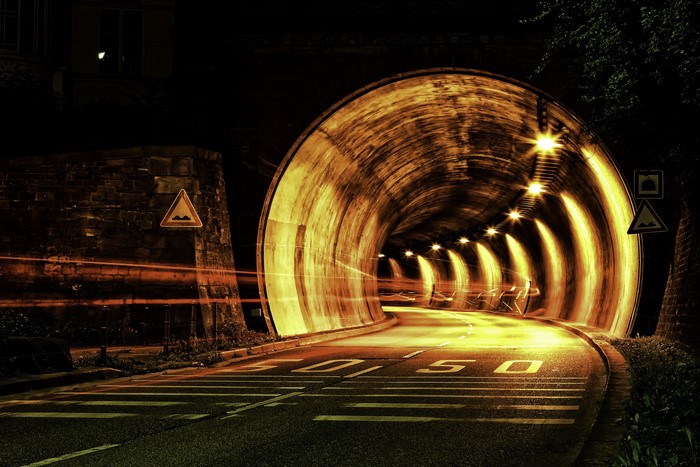 Illuminated Night Road Tunnel with Light Trails 4K