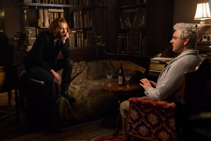 Crowley and Aziraphale in a library with wine