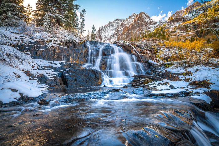 Snowy Mountain Waterfall with Autumn Colors