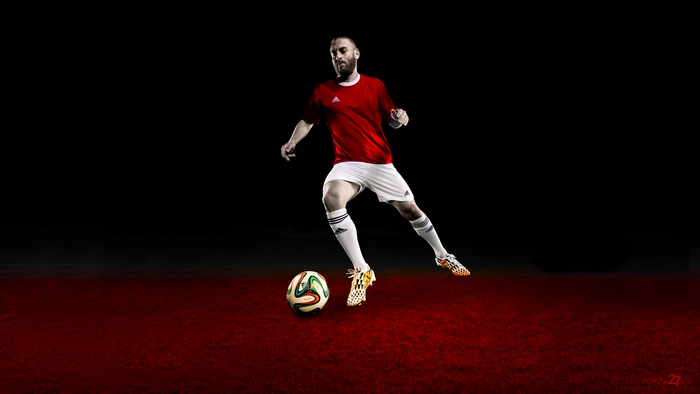 Daniele De Rossi playing soccer on a red field