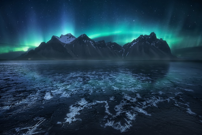 Aurora Borealis over Iceland's Mountains and Icy Shore