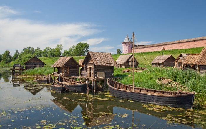 Suzdal river village with traditional boats and monastery