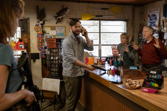 Ike Barinholtz holds gun, people surrender in The Hunt (2020)