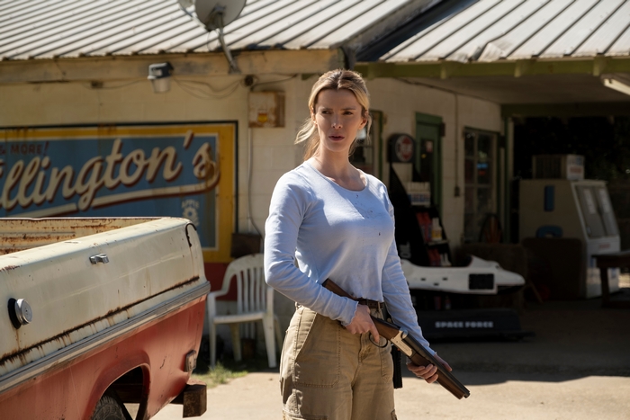 Betty Gilpin holding a shotgun in The Hunt