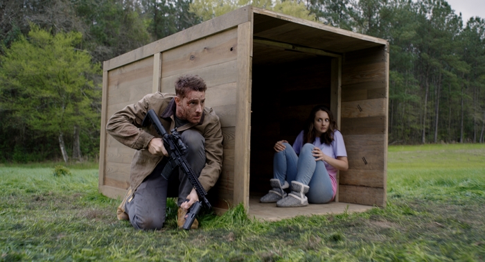 Justin Hartley protects woman with rifle in The Hunt