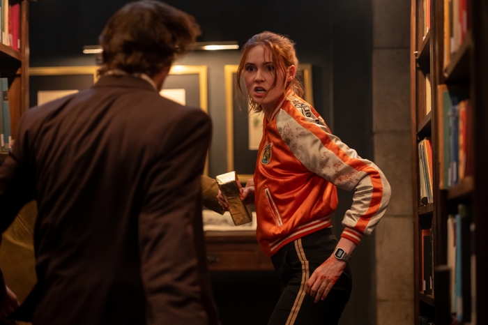 Karen Gillan with gold bar in Gunpowder Milkshake