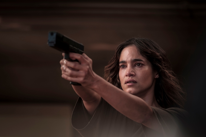 Settlers: Sofia Boutella aiming a pistol