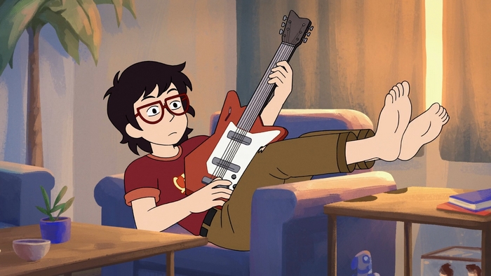 Ryan Akagi playing guitar with feet up