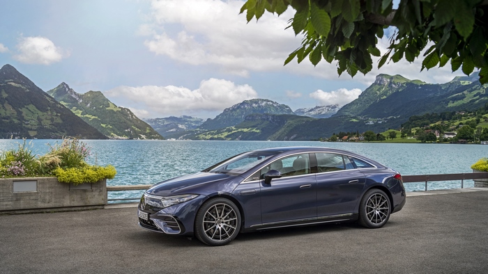 Blue Mercedes-Benz EQS 450+ AMG Line by a scenic lake