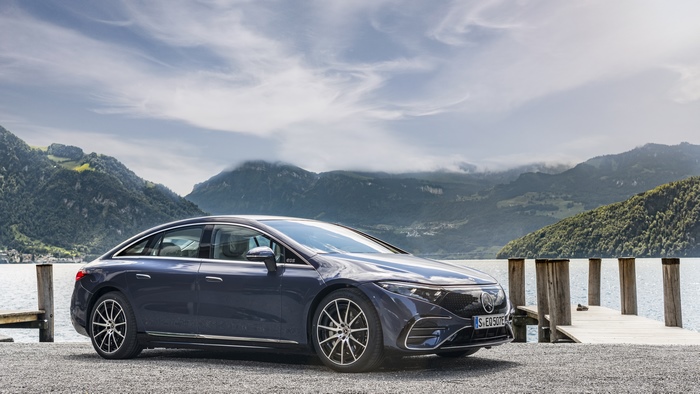 Luxury Mercedes-Benz EQS electric car by mountain lake