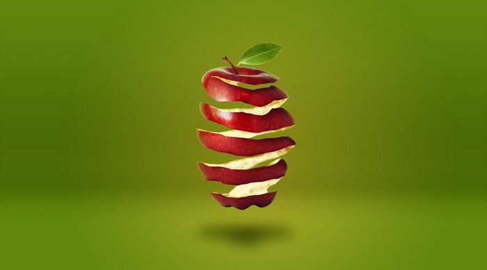 Artistic floating peeled apple