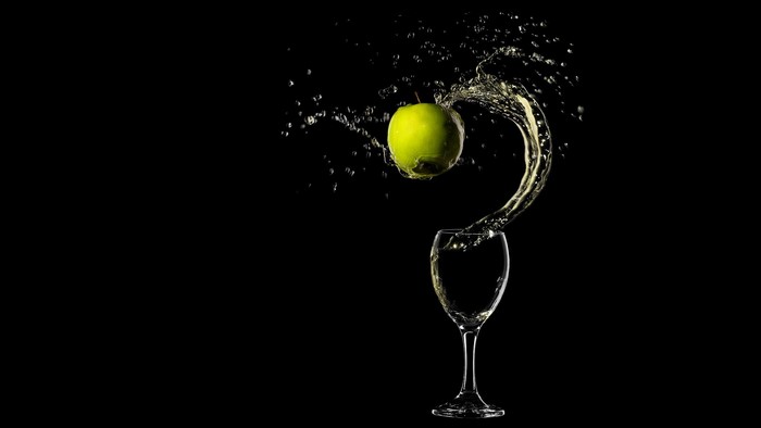 Green Apple Splashing Water into Glass