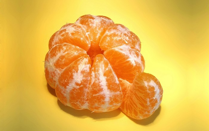 Peeled Mandarin Orange Segments on Yellow