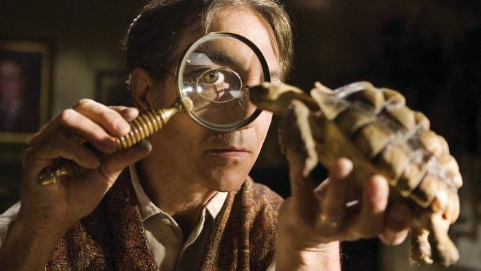 Arthur Spiderwick examining a tortoise with a magnifying glass