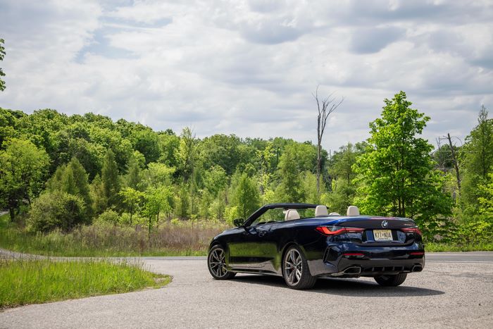 Blue 2021 BMW M440i Cabriolet on a scenic road