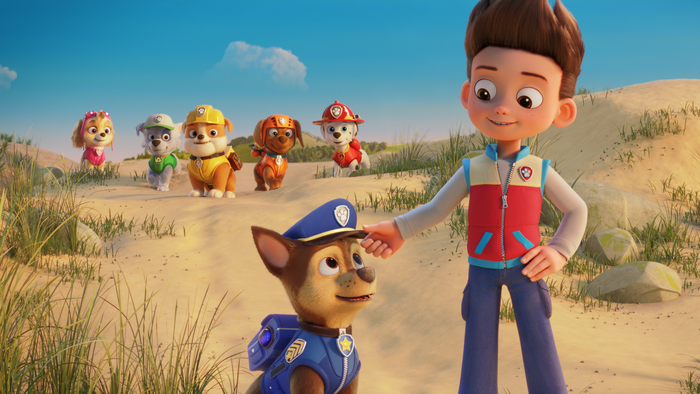 Paw Patrol: The Movie Ryder petting Chase and pups