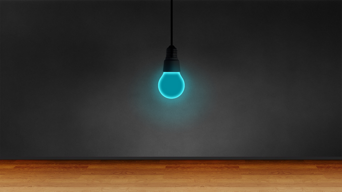 Artistic Blue Light Bulb in a Dark Room