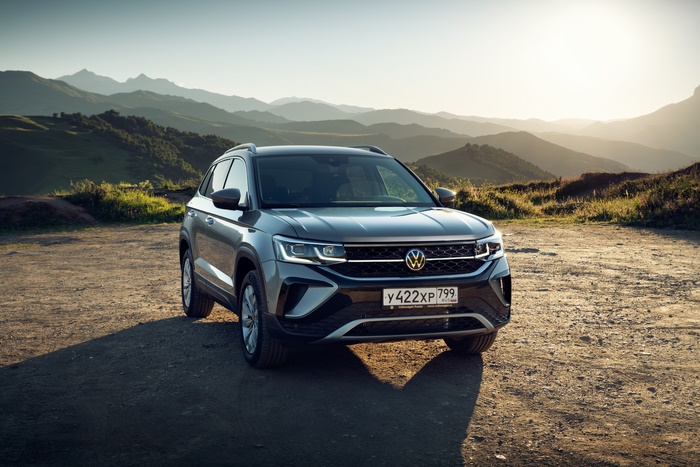 Grey Volkswagen Taos SUV parked in a mountain landscape