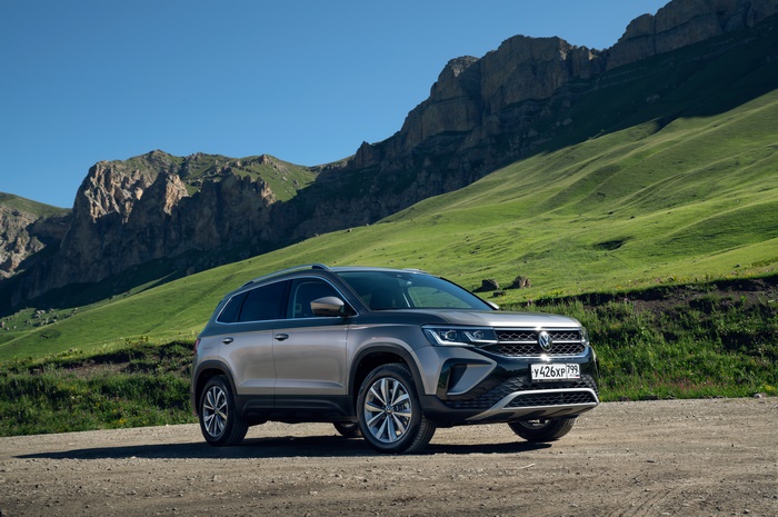 Grey Volkswagen Taos SUV on a mountain road