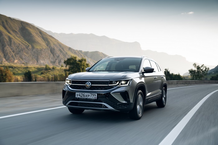 Grey 2021 Volkswagen Taos 4MOTION SUV on a mountain road