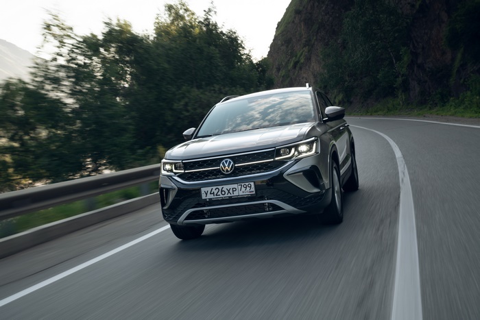 Grey Volkswagen Taos 4MOTION SUV on a winding road