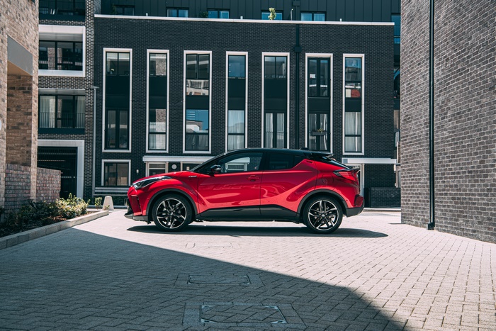 Red Toyota C-HR Hybrid GR Sport SUV in city