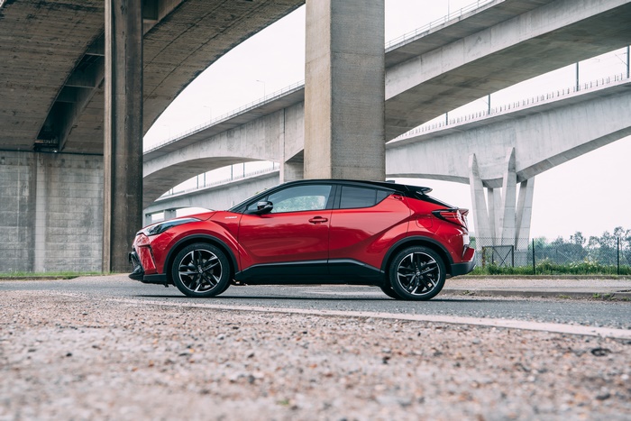 Red Toyota C-HR Hybrid GR Sport SUV under bridge