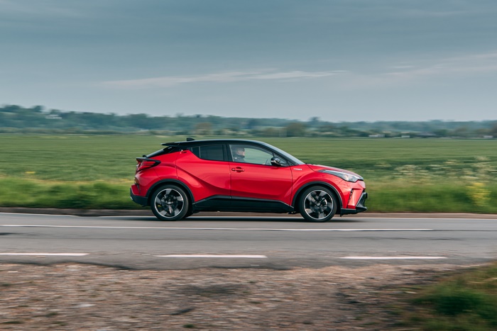Red Toyota C-HR Hybrid GR Sport SUV driving