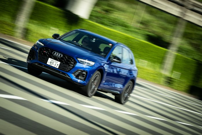 Blue Audi SQ5 SUV driving on road with motion blur