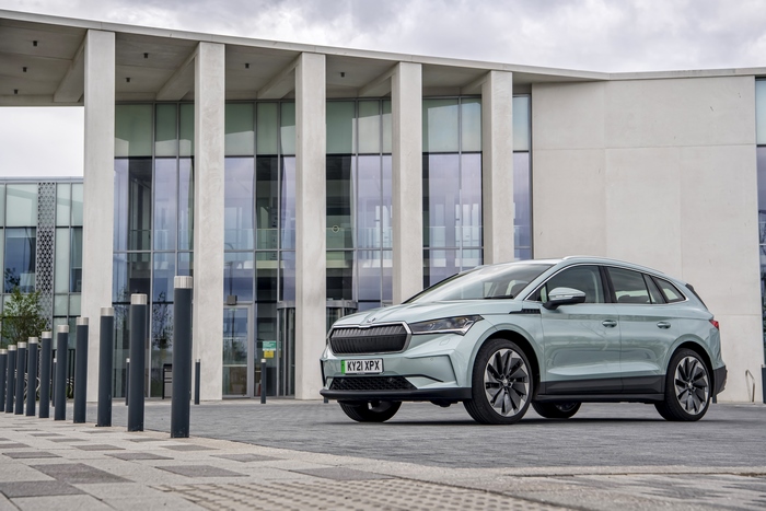 Škoda Enyaq Electric SUV in front of a modern building