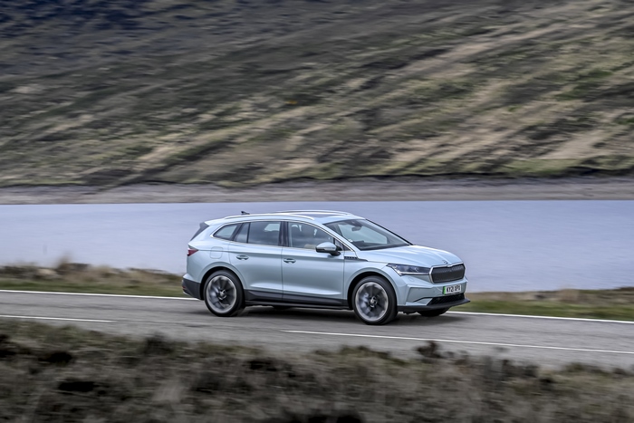 Škoda Enyaq iV 80 electric SUV driving by a lake
