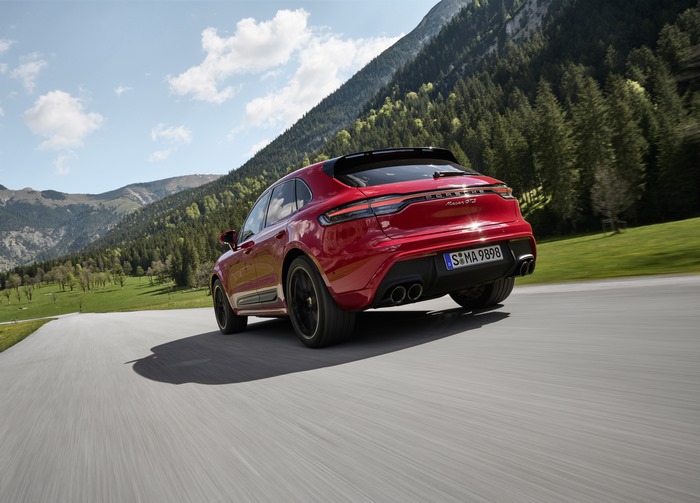 Red Porsche Macan GTS driving through mountains